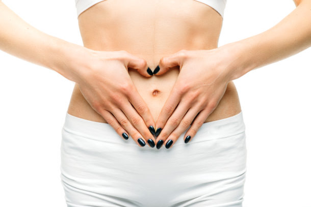 Female person stomach, white background Female person stomach, white background, healthcare, medicine advertising or concept